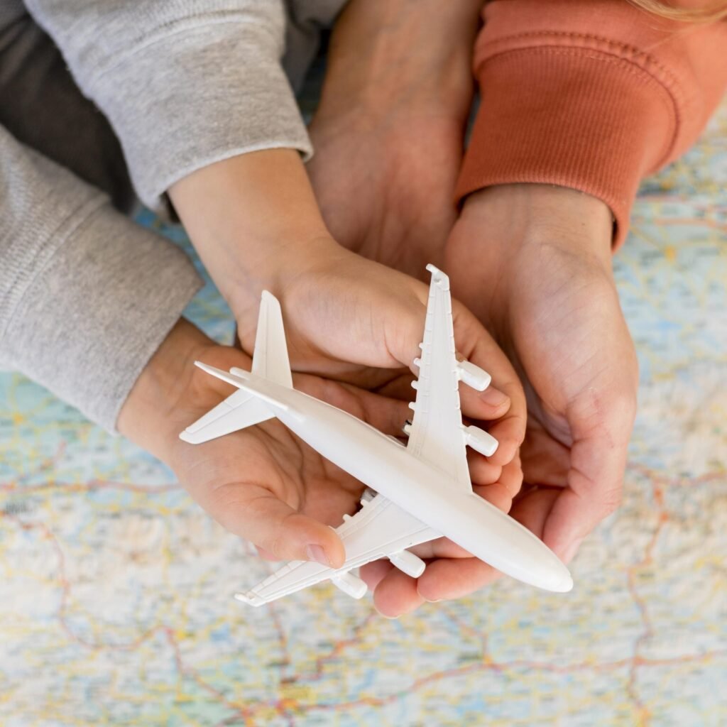 mother-child-home-holding-airplane-figurine-top-map
